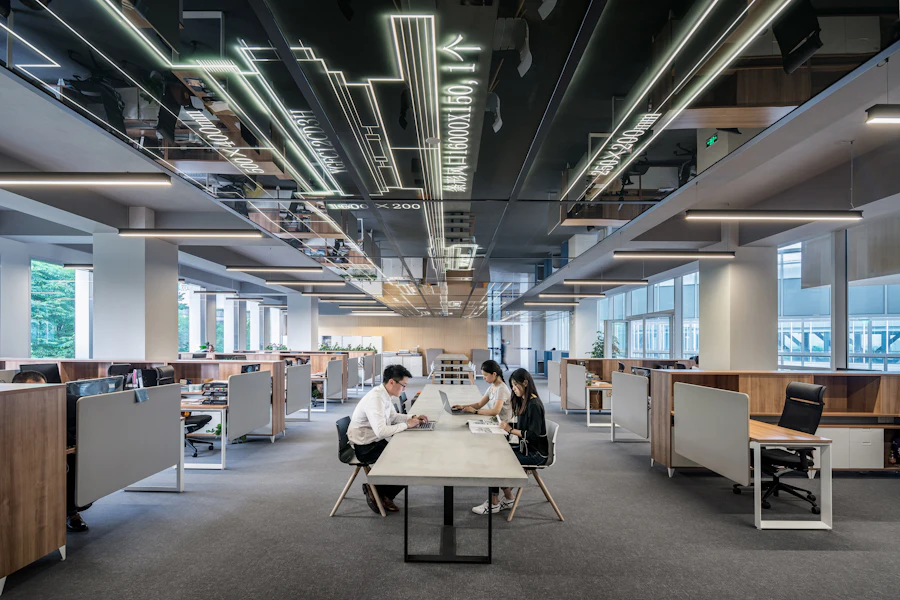 Calm open-plan office with people working at a shared table